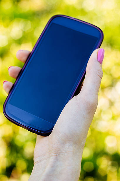 istock Woman holding phone 474975736