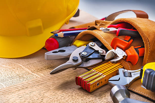set of construction tools in toolbelt close up on wooden