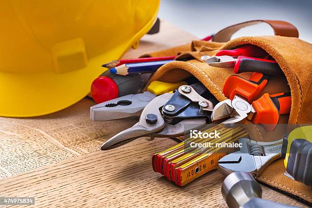 Set Of Construction Tools In Toolbelt Close Up On Wooden Stock Photo - Download Image Now