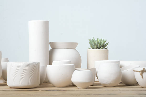 istock Not glazed pot on wood tableUnglazed white clay pots 474977528