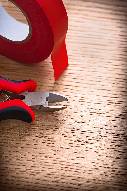 istock vertical view nippers with insulating tape on wooden board 474981014