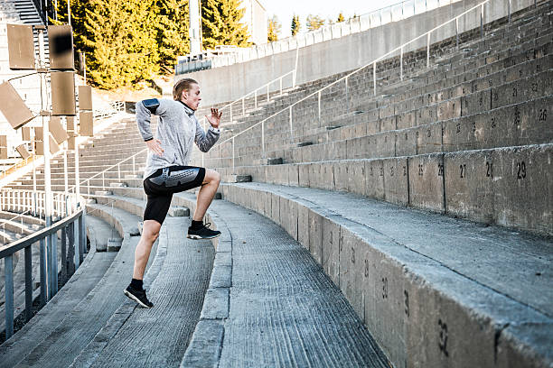 istock Young man exercising in early morning running on steps 474986136