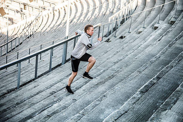 istock Young man exercising in early morning running on steps 474986310