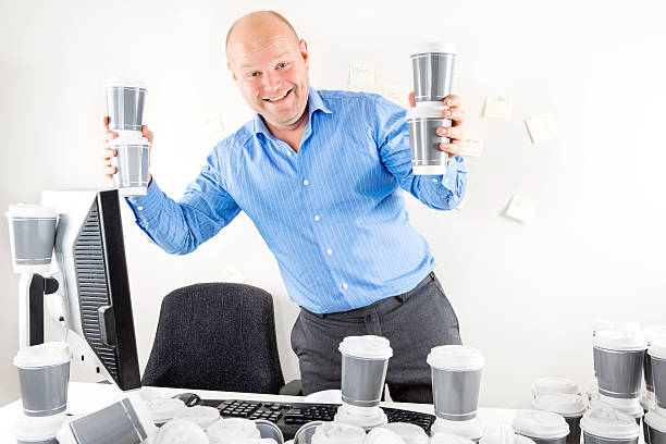 istock Happy businessman drinks too much coffee 474990110