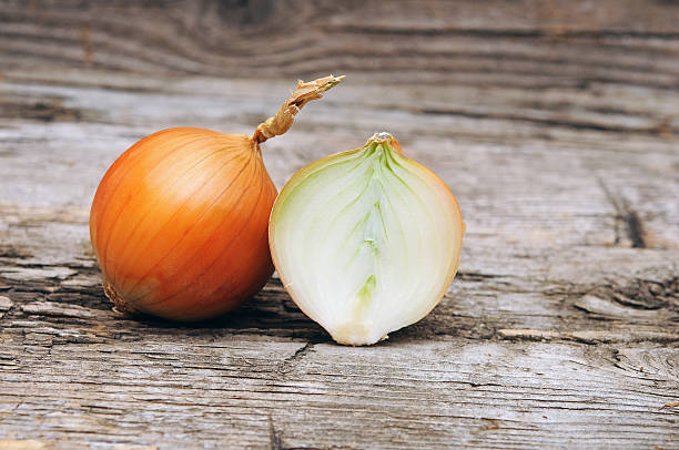 istock organic onions on wooden background 474991839