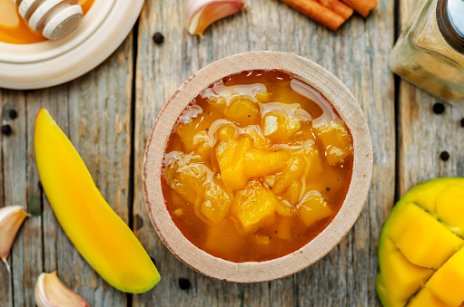 mango chutney on a dark wood background. the toning. selective focus