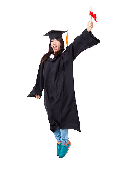 istock Happy  student in graduate robe jumping isolated on white 474996846