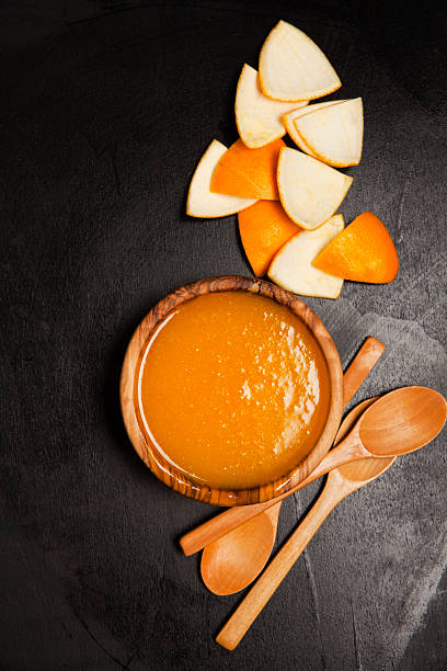 istock hot custard from oranges. on dark. wooden  utensil 474996934