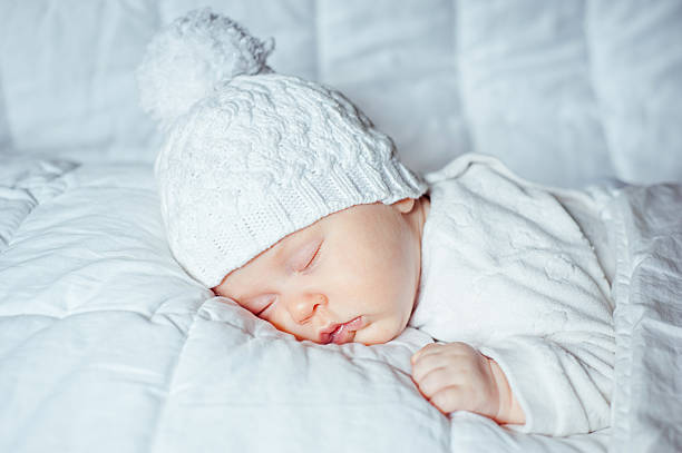 istock little baby sleeping sweetly in white hat 474997102