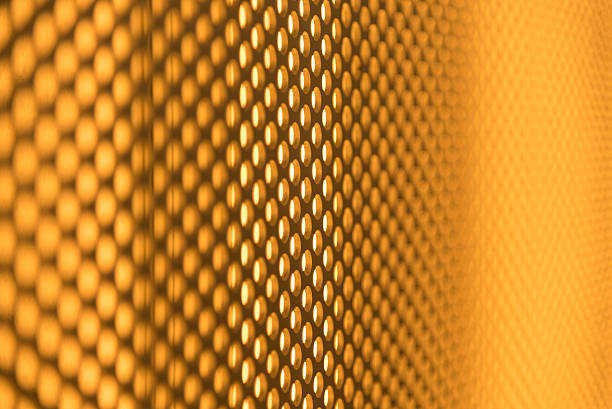 istock golden perforated metal plate background 474997818