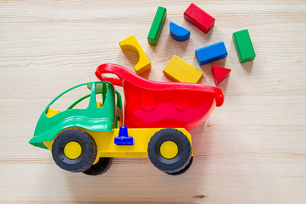 istock Toy car truck with bricks, wood background 474999836
