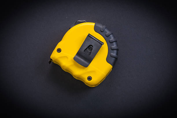 istock yellow tapeline on black background 475000822