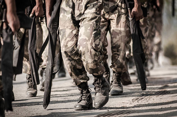 istock running soldiers carrying weapons 475000847