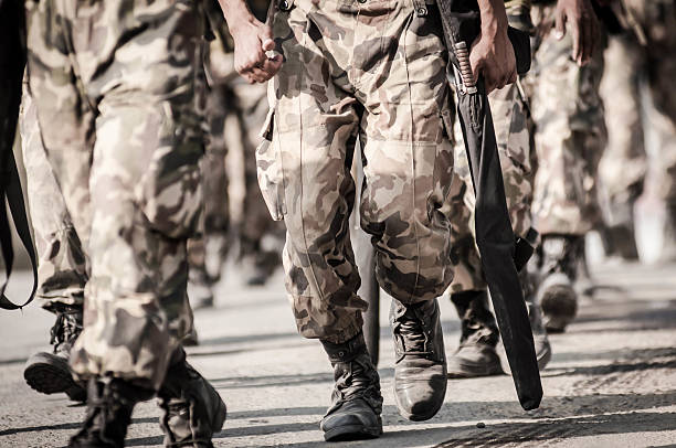 istock running soldiers carrying weapons 475000853