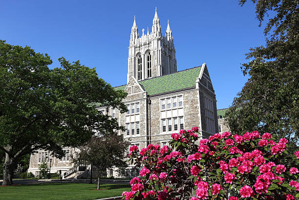 Boston College Chestnut Hill, Massachusetts, USA - May 24, 2015: Gasson Hall surrounded by spring flowers on the campus of Boston College boston college campus stock pictures, royalty-free photos & images