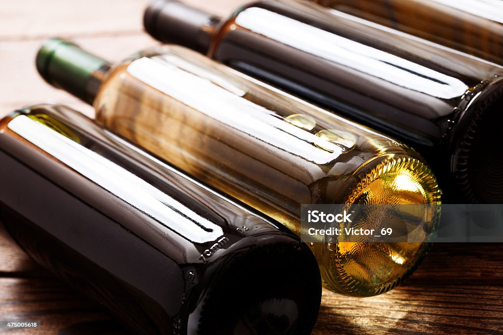 Wine bottles on wooden background Wine bottles on wooden background. Flat mock up for design. 2015 Stock Photo