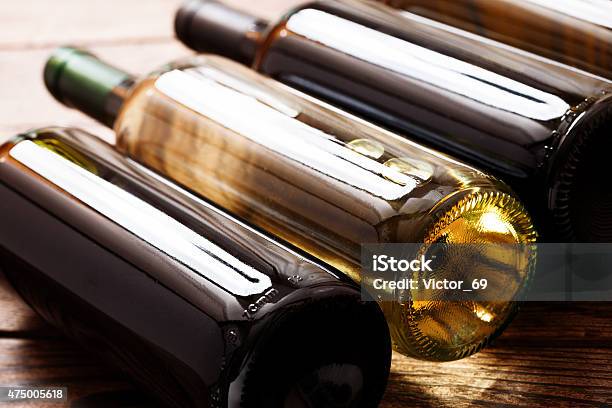 Wine Bottles On Wooden Background Stock Photo - Download Image Now - 2015, Alcohol Abuse, Arrangement