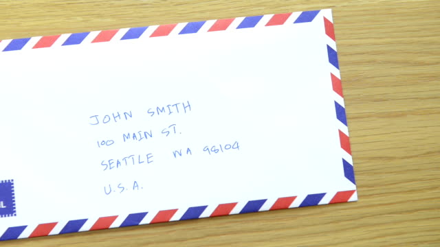 CNGLOTH97 - People putting stamps on letter and package