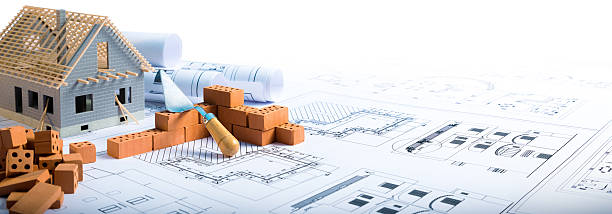 house in construction - project with brick and blueprint