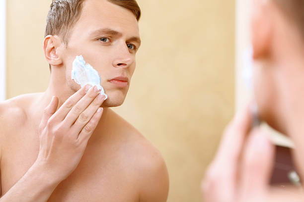 istock Topless man applying mean of shaving on face 475009906