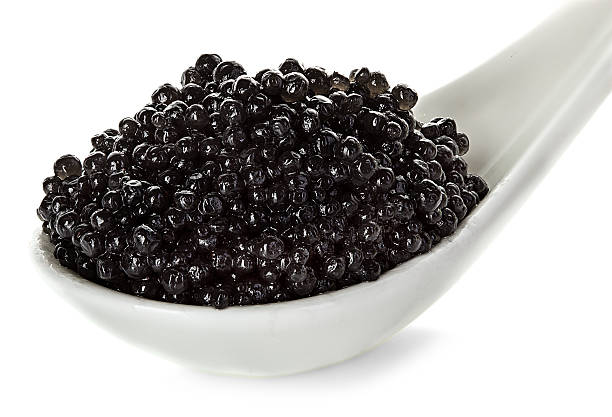 istock Black caviar in a spoon isolated on white background 475010658