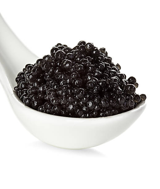 istock Black caviar in a spoon isolated on white background 475010660