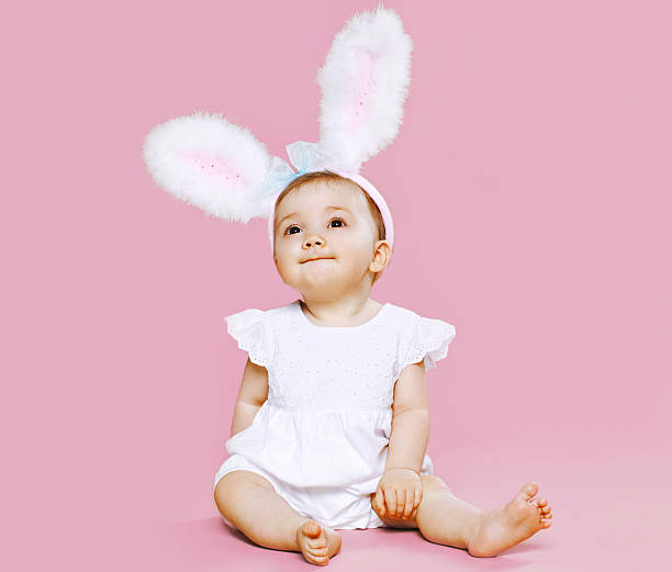 istock Sweet pink cute baby sitting in costume easter bunny 475011176