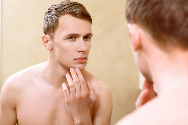 istock Topless man touching his face with fingers 475012066