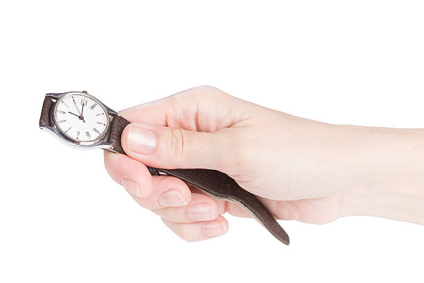 istock Female hand holding an old watch 475021588
