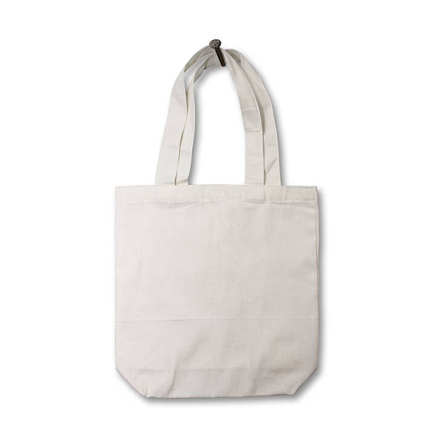 istock White cotton bag hanging on a wooden wall 475025087