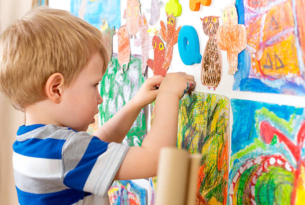 istock Little Boy Painting 475029266