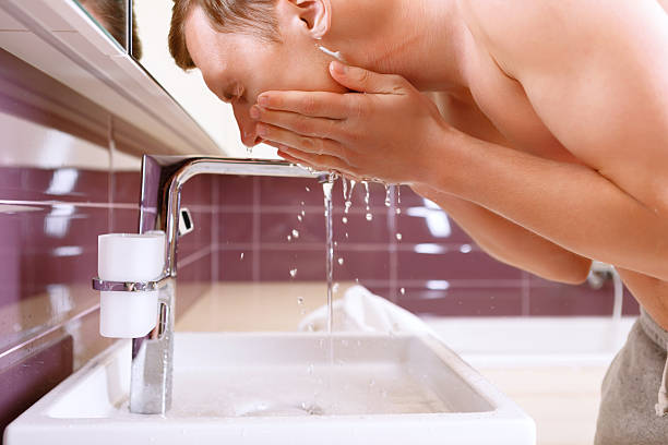 istock Man washing his face in bathroom 475029888