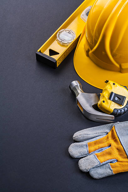 istock glove hammer tapeline level helmet on black background 475032930