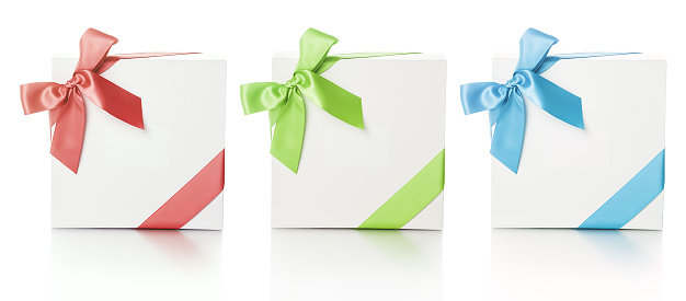 Tthree elegant white gift boxes with color silk ribbons over white background. Luxury gift service.