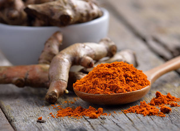 istock pile of fresh turmeric roots on wooden table 475033530