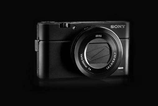 Hamburg, Germany - November 22, 2014: Studio shot of a Sony Cyber-shot DSC-RX100 III digital camera on black background.