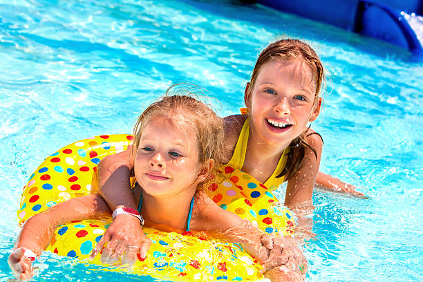 istock Children  in swimming pool 475033648