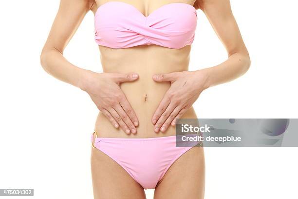 Woman With Hands Over Belly Stock Photo - Download Image Now - Pink Color, Uterus, Women