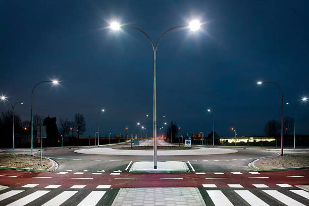 Roundabout illuminated by led lights  at twilight Roundabout illuminated by led lights in the twilight zone street light stock pictures, royalty-free photos & images