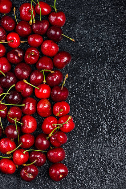 istock Fresh ripe organic cherries on black border  background 475034512