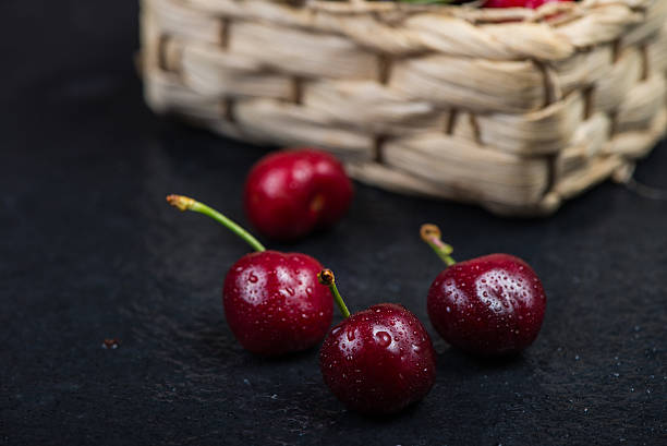 istock Fresh ripe organic cherries on black border  background 475034768
