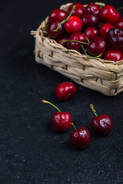 istock Fresh ripe organic cherries on black border  background 475035264