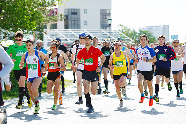Marathon athletes running on street. stock photo