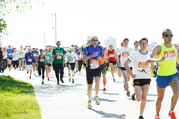 Omsk, Russia - May 24, 2015: Marathon runners compete at the Spring Half Marathon 2015 in Omsk, Russia. Marathon athletes running on street.