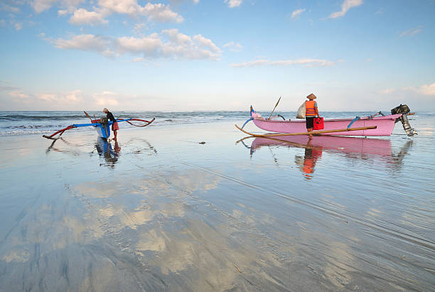 Bali, Indonesia, August 3, 2011 : Group of Balinese fishermen were preparing their boat before heading for the sea.