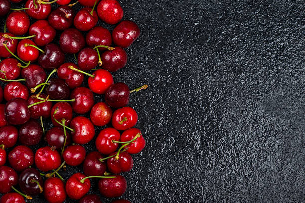 istock Fresh ripe organic cherries on black border  background 475037564