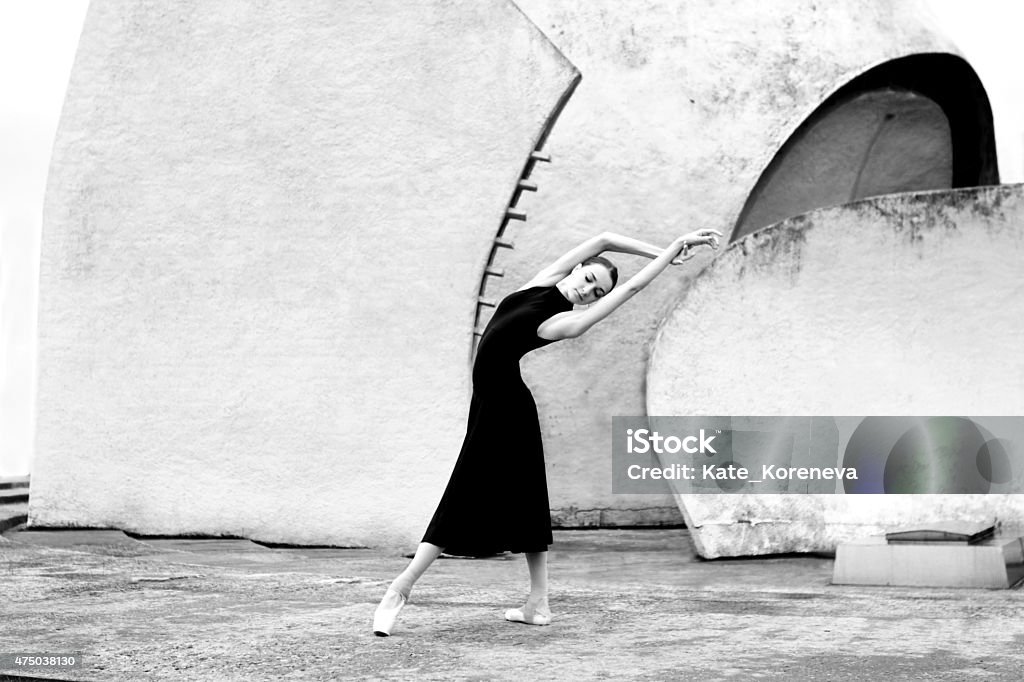 Ballet on the streets Ballerina  stands in dance pose  on the building background. 2015 Stock Photo