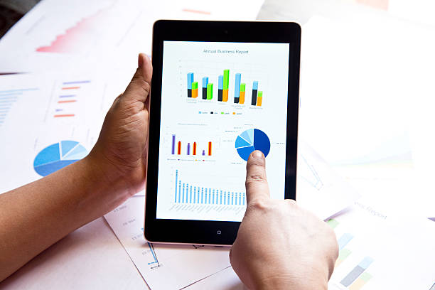 istock Businessman checking business reports on digital tablet 475041626