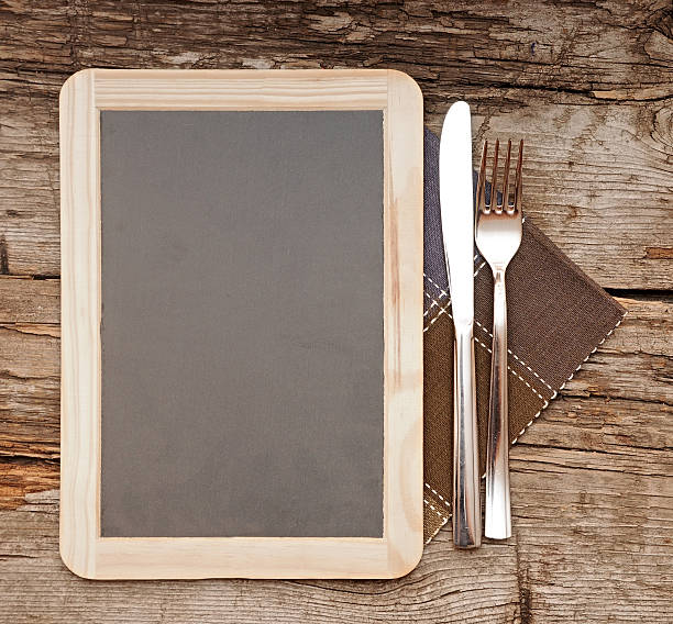 istock Menu blackboard lying on old  wooden table 475042089