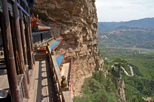 A Taoist temple carved in rock with large vistas of space below in North China, near Datong, Shanxi Province